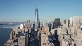 4.8K aerial stock footage approach Freedom Tower and tilt to World Trade Center Memorial with snow, New York City Aerial Stock Footage | AX66_0137E