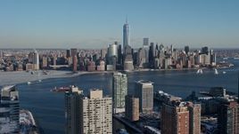4.8K aerial stock footage approach Lower Manhattan skyscrapers in snow, New York City Day Aerial Stock Footage | AX66_0166E