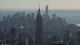 4.8K aerial stock footage of the Empire State Building, with Lower Manhattan in the background in winter, New York City Aerial Stock Footage | AX66_0210E