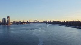 4.8K aerial stock footage follow East River to approach Williamsburg Bridge, New York City at sunset Aerial Stock Footage | AX66_0228