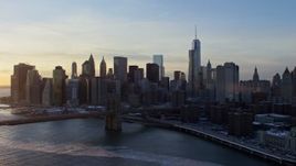 4.8K aerial stock footage approach Brooklyn Bridge and Lower Manhattan skyline, New York City, sunset Aerial Stock Footage | AX66_0234