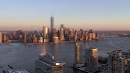 4.8K aerial stock footage approach Lower Manhattan skyline across the river in New York City, sunset Aerial Stock Footage | AX66_0251