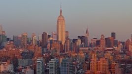 4.8K aerial stock footage of the Empire State Building and Midtown skyscrapers in New York City, sunset Aerial Stock Footage | AX66_0266E