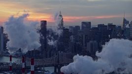 4.8K aerial stock footage of Midtown Manhattan smoke stacks and skyscrapers in winter, New York City, twilight Aerial Stock Footage | AX66_0317E