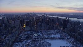 4.8K aerial stock footage of Central Park beside Midtown skyscrapers in winter, New York City, twilight Aerial Stock Footage | AX66_0332E