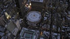 4.8K aerial stock footage fly away from Madison Square Garden in winter, New York City, twilight Aerial Stock Footage | AX66_0342
