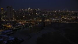 4.8K aerial stock footage approach Brooklyn Bridge in winter, New York City, night Aerial Stock Footage | AX66_0404