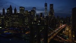 4.8K aerial stock footage approach and orbit Brooklyn Bridge, reveal Lower Manhattan skyscrapers in winter, New York City, twilight Aerial Stock Footage | AX66_0404E