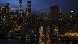 4.8K aerial stock footage orbit Brooklyn Bridge, reveal Lower Manhattan skyscrapers in winter, New York City, twilight Aerial Stock Footage | AX66_0406
