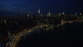 4.8K aerial stock footage of smoke stacks and Midtown Manhattan skyline in winter, New York City, night Aerial Stock Footage | AX66_0411E