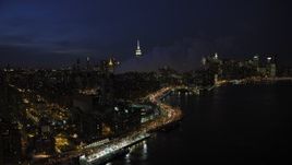 4.8K aerial stock footage of smoke stacks and Midtown Manhattan skyline in winter, New York City, night Aerial Stock Footage | AX66_0412
