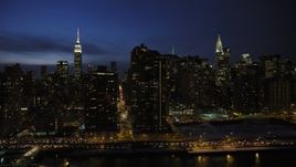 4.8K aerial stock footage passing Midtown Manhattan skyscrapers, New York City, night Aerial Stock Footage | AX66_0417