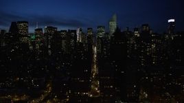 4.8K aerial stock footage of Midtown Manhattan's tall skyscrapers and city streets, New York City, night Aerial Stock Footage | AX66_0421