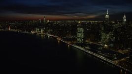 4.8K aerial stock footage of a view of Midtown and Lower Manhattan skyscrapers, New York City, night Aerial Stock Footage | AX66_0440E