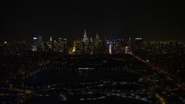 4.8K aerial stock footage view of Midtown Manhattan and Central Park reservoir at night in winter, New York City, New York Aerial Stock Footage | AX67_0014