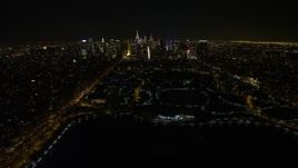 4.8K aerial stock footage view of flying over the Central Park reservoir to approach Midtown skyline, New York City, New York Aerial Stock Footage | AX67_0015