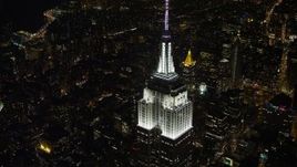 4.8K aerial stock footage view of the top of the Empire State Building at night, Midtown Manhattan, New York City, New York Aerial Stock Footage | AX67_0021