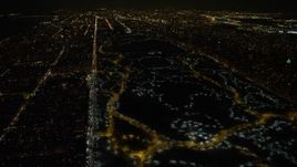 4.8K aerial stock footage view of lit pathways through Central Park in winter at night, New York City, New York Aerial Stock Footage | AX67_0025