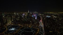 4.8K aerial stock footage view of Times Square, skyscrapers, and Columbus Circle in Midtown Manhattan at night in winter, New York City, New York Aerial Stock Footage | AX67_0026