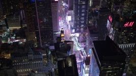 4.8K aerial stock footage view orbit Times Square and skyscrapers at night in Midtown Manhattan, New York City, New York Aerial Stock Footage | AX67_0035