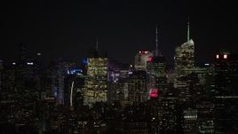 4.8K aerial stock footage view a group of towering skyscrapers at night, Midtown Manhattan, New York City, New York Aerial Stock Footage | AX67_0051