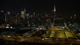 4.8K aerial stock footage view of passing Hudson Yards and Hell's Kitchen skyscrapers at night, Midtown Manhattan, New York City Aerial Stock Footage | AX67_0053