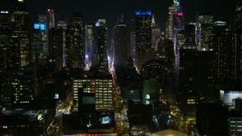 4.8K aerial stock footage view of flying by Hell's Kitchen skyscrapers at night, Midtown Manhattan, New York City, New York Aerial Stock Footage | AX67_0055