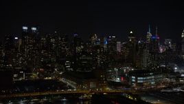 4.8K aerial stock footage view of panning right across Midtown Manhattan skyscrapers at night, New York Aerial Stock Footage | AX67_0057