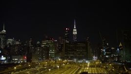4.8K aerial stock footage view of the Empire State Building at night seen from Hudson Yards, Midtown, New York Aerial Stock Footage | AX67_0062