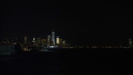 4.8K aerial stock footage view of tilting from the Hudson River to reveal the World Trade Center skyline at night, New York Aerial Stock Footage | AX67_0064