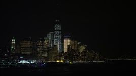 4.8K aerial stock footage view of World Trade Center skyscrapers seen from the Hudson River at night, New York City Aerial Stock Footage | AX67_0065