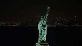 4.8K aerial  video of orbiting the back of the Statue of Liberty at night, reveal World Trade Center skyline, New York Aerial Stock Footage | AX67_0074