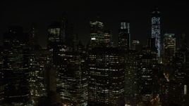 4.8K aerial stock footage view of flying by Lower Manhattan's tall skyscrapers at night, New York Aerial Stock Footage | AX67_0082