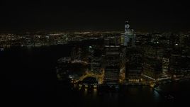 4.8K aerial stock footage view of orbiting Lower Manhattan skyscrapers and Battery Park at night, New York Aerial Stock Footage | AX67_0083