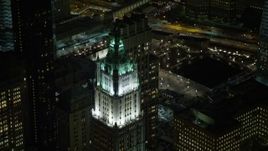4.8K aerial stock footage view of flying by top of Woolworth Building at night, Lower Manhattan, New York Aerial Stock Footage | AX67_0089
