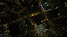 4.8K aerial stock footage view of tilting to a bird's eye view of skyscrapers and streets in Lower Manhattan at night, New York Aerial Stock Footage | AX67_0090