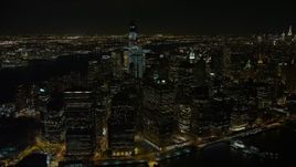 4.8K aerial stock footage view of Lower Manhattan skyscrapers by East River at night, Lower Manhattan, New York Aerial Stock Footage | AX67_0099