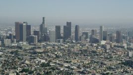 4.8K stock aerial footage video tilt from Westlake apartment buildings to reveal Downtown Los Angeles, California Aerial Stock Footage | AX68_010
