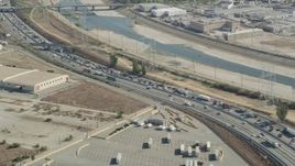 4.8K aerial stock footage of heavy traffic on a bend in I-710 by the Los Angeles River in Vernon, Los Angeles, California Aerial Stock Footage | AX68_036