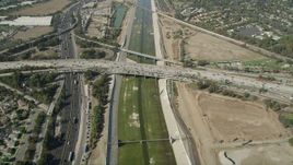 4.8K aerial stock footage reverse bird's eye view of the Los Angeles River, reveal freeway interchange in Long Beach, California Aerial Stock Footage | AX68_048