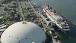 4.8K aerial stock footage reverse view of the Queen Mary luxury liner and reveal Downtown Long Beach, California Aerial Stock Footage | AX68_068