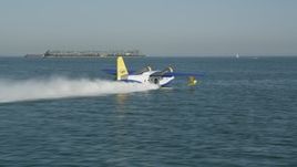 4.8K aerial stock footage track a seaplane taking off from San Pedro Bay in Long Beach, California Aerial Stock Footage | AX68_077