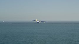 4.8K aerial stock footage of tracking seaplane approaching the San Pedro Bay breakwater, Long Beach, California Aerial Stock Footage | AX68_079