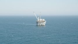 4.8K aerial stock footage tilt to reveal and approach an offshore oil platform near Long Beach, California Aerial Stock Footage | AX68_088