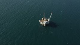 4.8K aerial stock footage of looking down at an oceanic oil platform near the coast of California, Long Beach Aerial Stock Footage | AX68_105