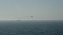 4.8K aerial stock footage of tracking a seaplane flying by oil tankers near San Pedro Bay, Long Beach, California Aerial Stock Footage | AX68_114