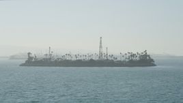 4.8K aerial stock footage approach the oil drilling Island Chaffee in San Pedro Bay, Long Beach, California Aerial Stock Footage | AX68_126