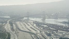 4.8K aerial stock footage approach train yard and Vincent Thomas Bridge at the Port of Los Angeles, California Aerial Stock Footage | AX68_144