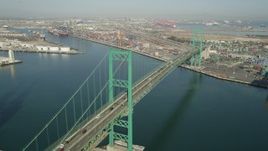 4.8K aerial stock footage approach the Vincent Thomas Bridge at the Port of Los Angeles, California and tilt to traffic Aerial Stock Footage | AX68_156