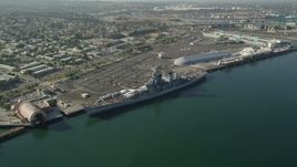 4.8K aerial stock footage reverse view of the USS Iowa and the Port of Los Angeles, California Aerial Stock Footage | AX68_160